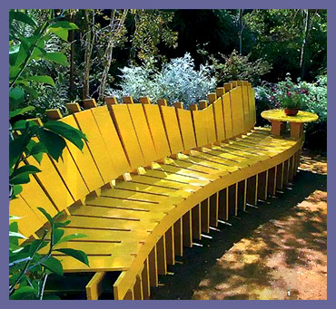 Длинная скамья оригинальной формы, окрашенная в желтый цвет.